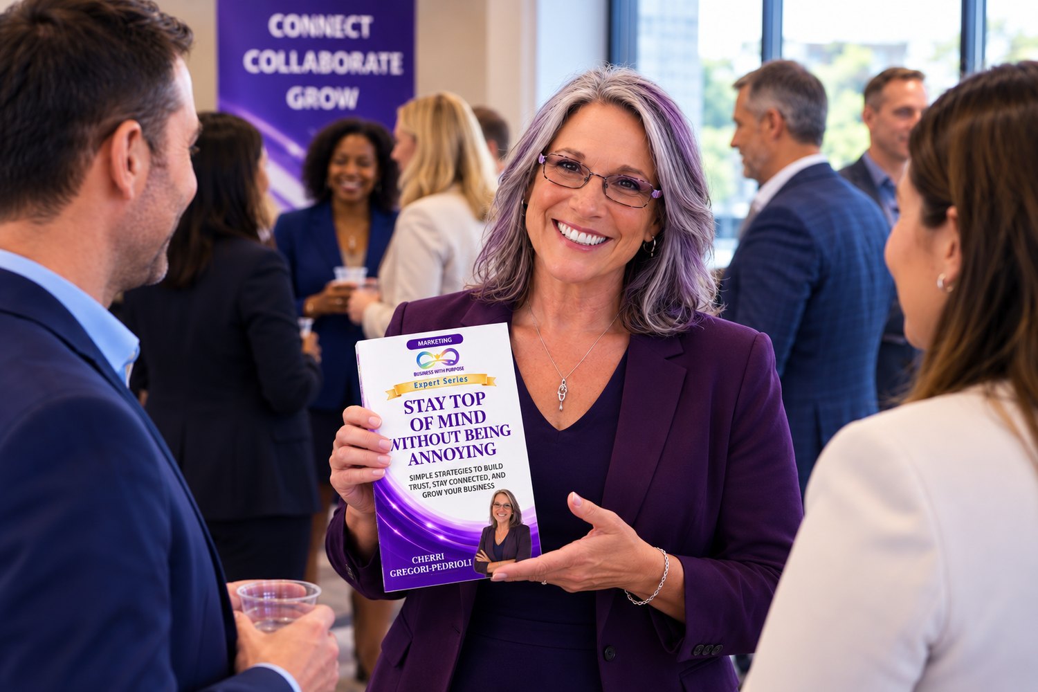 Expert Series author Cherri Gregori-Pedrioli holding her book, Stay Top of Mind Without Being Annoying, at a Business With Purpose networking event
