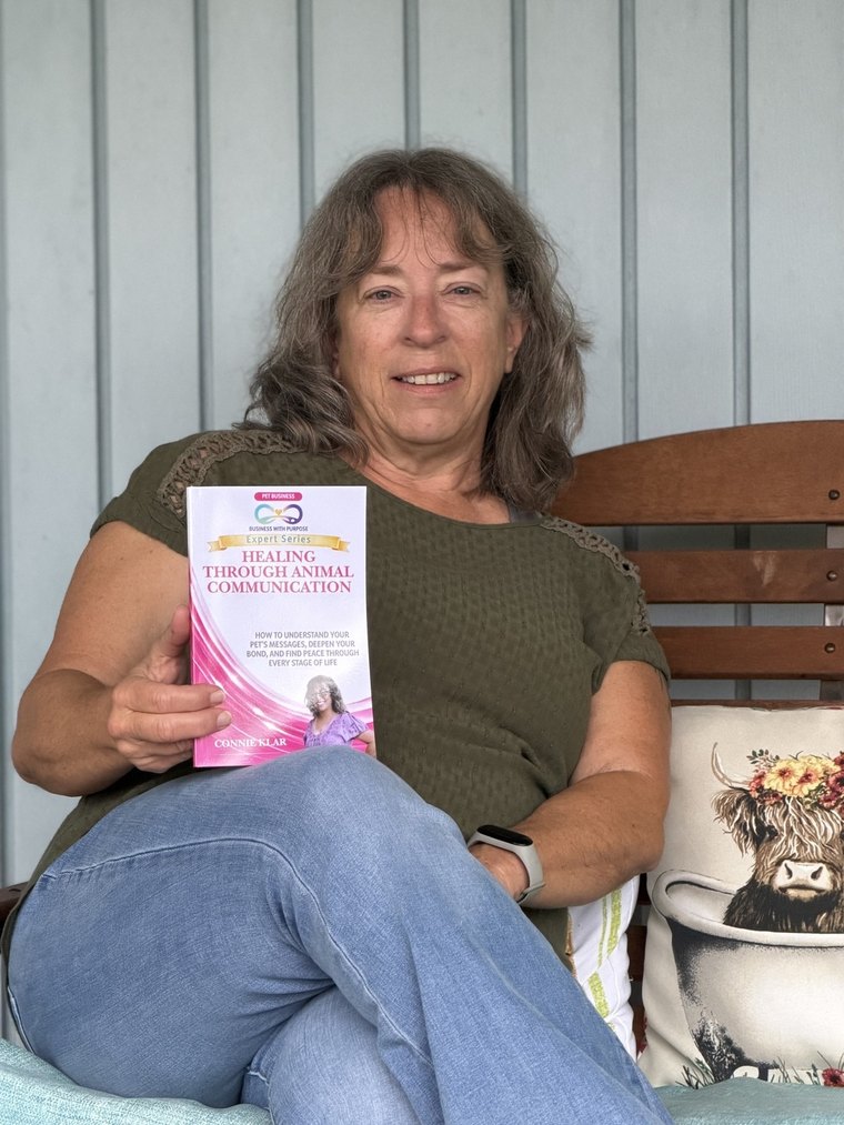 Connie Klar holding her BWP Expert Series book, Healing Through Animal Communication