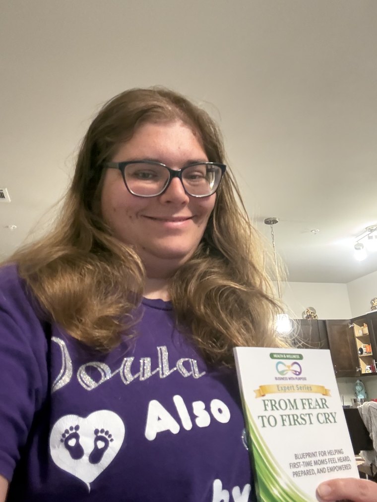 Melanie Powell holding her BWP Expert Series book, From Fear to First Cry