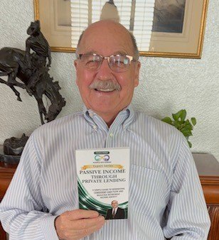 Tom Chase holding his BWP Expert Series book, Passive Income Through Private Lending